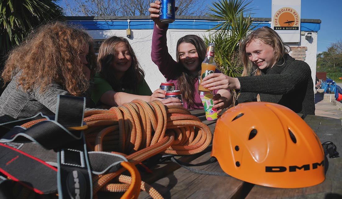 4 girls enjoying a drink after a rock climbing excursion outside The Paddlers Return